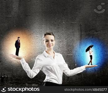 Emotional balance. Image of businesswoman holding business persons in miniature on palms