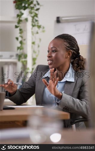 Emotional businesswoman gesturing during meeting at office