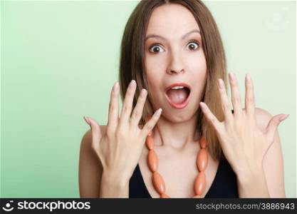 Emotional facial expression wide eyed woman surprised girl open mouth hand gesture.