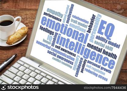 emotional intelligence (EQ) word cloud on a laptop screen with a cup of coffee,