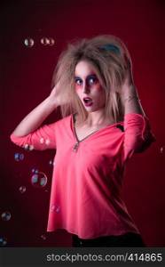 Emotional Portrait of a Attractive young girl with carnival colorful makeup and disheveled hair. Attractive young girl with disheveled hair