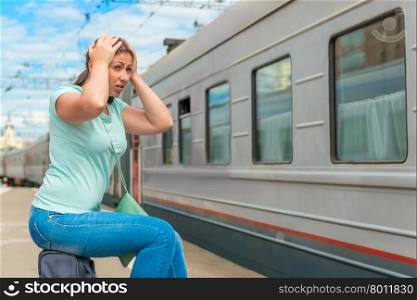 emotional woman looks at the departing train on which she was late