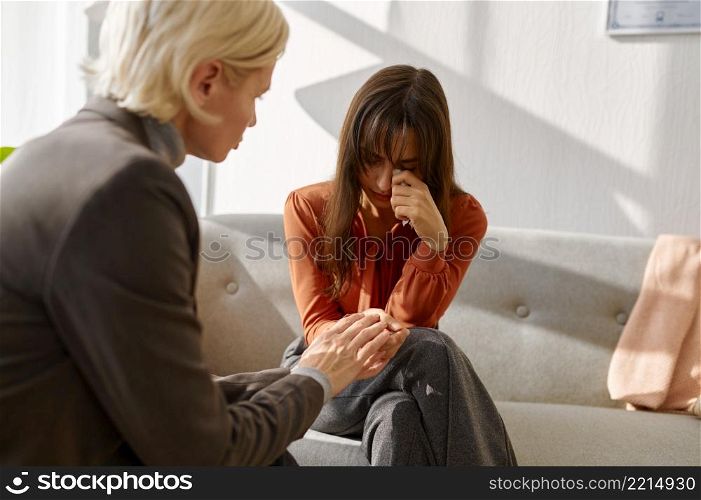 Emotional woman patient talking to psychologist at psychotherapy session. Psychology mental therapy. Emotional young woman patient talking to psychologist