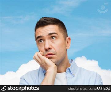 emotions and people concept - sad middle aged man over blue sky and cloud background