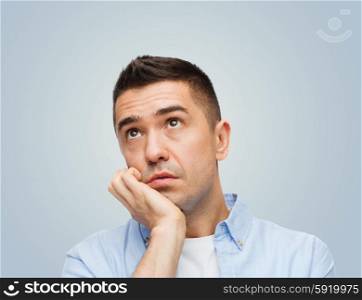 emotions, boredom, laziness and people concept - bored middle aged man over gray background