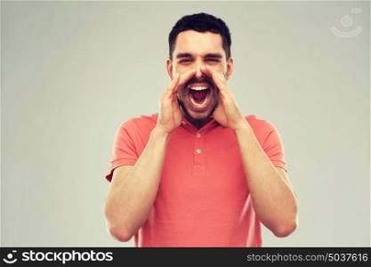 emotions, communication and people concept - angry shouting man in t-shirt over gray background. angry shouting man in t-shirt over gray background