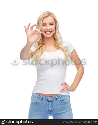 emotions, expressions, advertisement and people concept - happy smiling young woman or teenage girl in white t-shirt showing ok hand sign