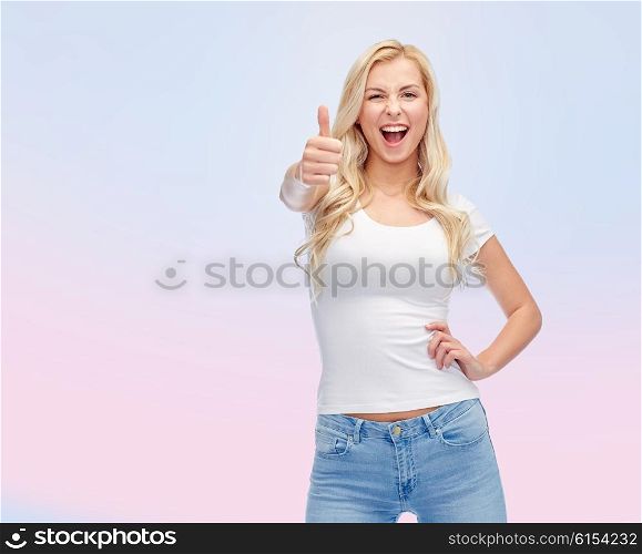 emotions, expressions, advertisement and people concept - happy smiling young woman or teenage girl in white t-shirt showing thumbs up over rose quartz and serenity gradient background