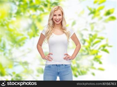 emotions, expressions, advertisement and people concept - happy smiling young woman or teenage girl in white t-shirt over green natural background