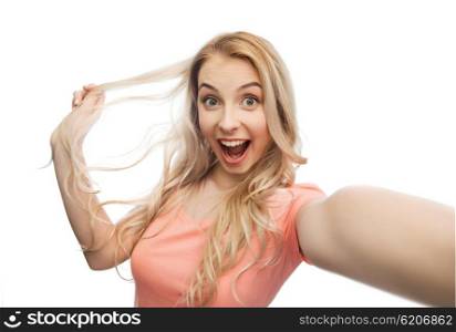 emotions, expressions and people concept - happy smiling young woman or teenage girl taking selfie