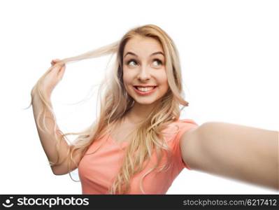 emotions, expressions and people concept - happy smiling young woman or teenage girl taking selfie