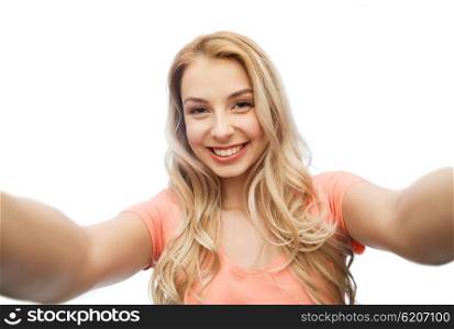 emotions, expressions and people concept - happy smiling young woman taking selfie