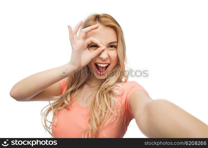emotions, expressions and people concept - happy smiling young woman taking selfie