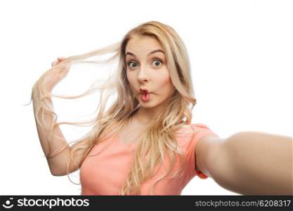 emotions, expressions and people concept - happy young woman taking selfie and making fish face