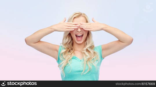 emotions, expressions and people concept - smiling young woman or teenage girl covering her eyes with palms over rose quartz and serenity gradient background