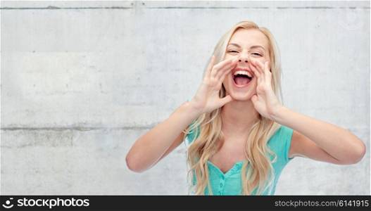 emotions, expressions and people concept - young woman or teenage girl shouting over gray concrete wall background