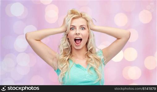 emotions, expressions, hairstyle and people concept - smiling young woman or teenage girl holding to her head or touching hair over pink holidays lights background