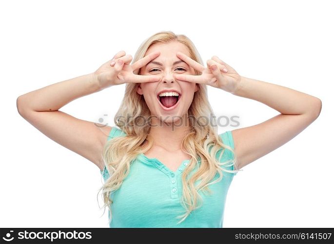 emotions, expressions, positive gesture and people concept - smiling young woman or teenage girl showing peace hand sign with both hands