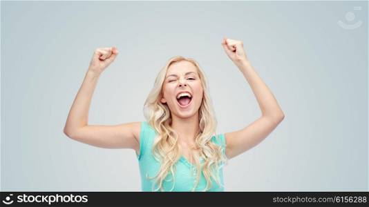 emotions, expressions, success and people concept - happy young woman or teenage girl celebrating victory over gray background
