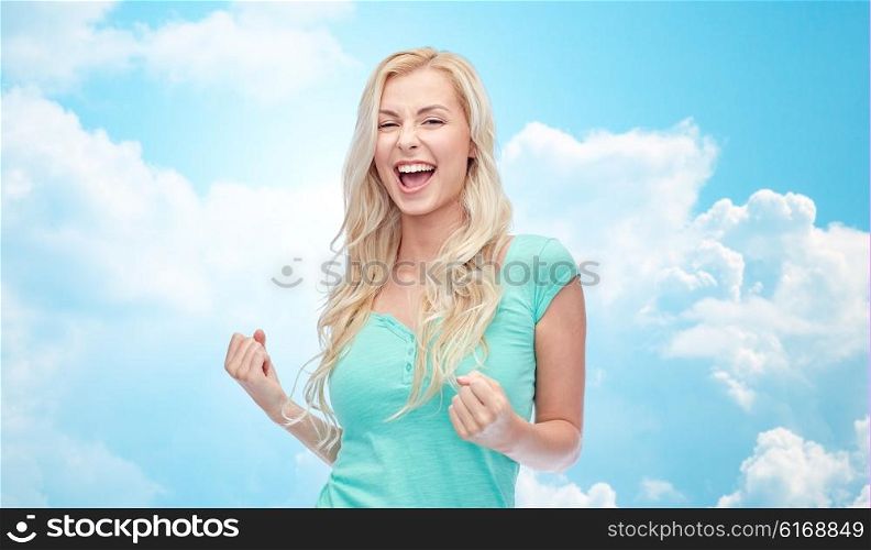 emotions, expressions, success and people concept - happy young woman or teenage girl celebrating victory over blue sky and clouds background