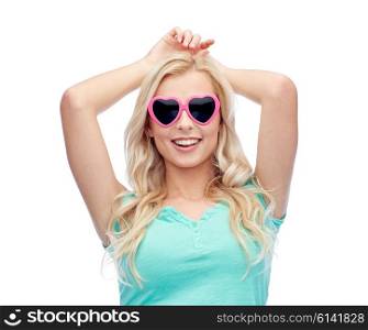emotions, expressions, summer and people concept - smiling young woman or teenage girl in heart shape sunglasses