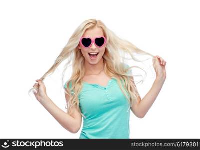 emotions, expressions, summer and people concept - smiling young woman or teenage girl in sunglasses holding her strand of hair
