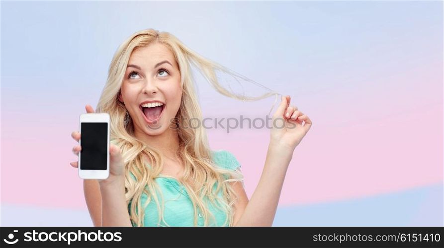emotions, expressions, technology and people concept - smiling young woman or teenage girl showing blank smartphone screen over pink background