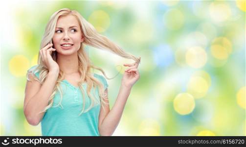 emotions, expressions, technology and people concept - smiling young woman or teenage girl calling on smartphone over green lights background