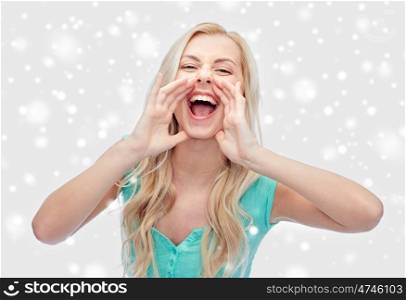 emotions, expressions, winter holidays, christmas and people concept - young woman or teenage girl shouting over snow