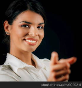 Emotions focus and determination. Face of a beautiful focused young woman, showing confidence, studio portrait, black background