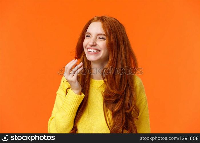 Emotions, holidays and positivity concept. Carefree modern hipster redhead girl having fun spend time with friends, laughing, smiling joyfully, giggle watching funny comedy movie, orange background.. Emotions, holidays and positivity concept. Carefree modern hipster redhead girl having fun spend time with friends, laughing, smiling joyfully, giggle watching funny comedy movie, orange background