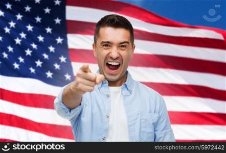 emotions, patriotism, citizenship, gesture and people concept - angry man shouting and pointing finger on you over american flag background