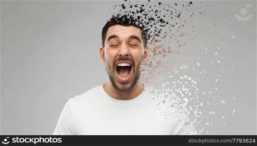 emotions, stress and people concept - crazy shouting man in t-shirt over gray background with particle dispersion effect. crazy shouting man in t-shirt over gray background