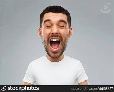 emotions, stress, madness and people concept - crazy shouting man in white t-shirt over gray background (funny cartoon style character with big head)