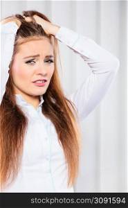 Emotions,stressful situation in work trouble and anxiety. Young woman in white shirt pull hair.. Stressed young woman pulling hair.