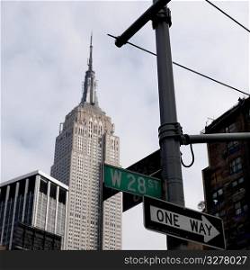Empire State Building and street signs in Manhattan, New York City, U.S.A.