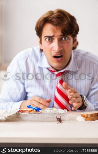 Employee eating food with cockroaches crawling around