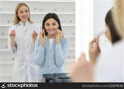 employee helping girl try glasses 6. employee helping girl try glasses 5