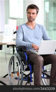 employee in wheelchair with laptop