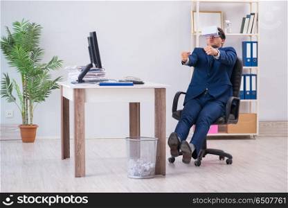 Employee using virtual reality glasses in office