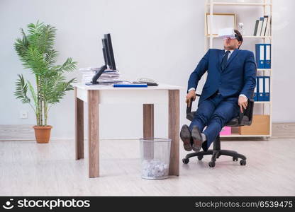 Employee using virtual reality glasses in office