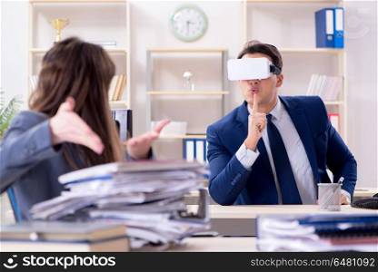 Employee with virtual reality glasses in office
