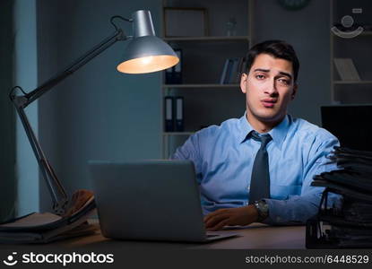 Employee working late at night at important report