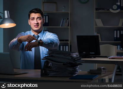 Employee working late at night at important report