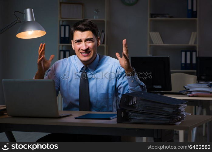 Employee working late at night at important report