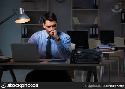 Employee working late at night at important report