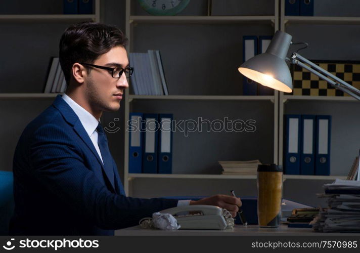 Employee working late to finish important deliverable task. The employee working late to finish important deliverable task