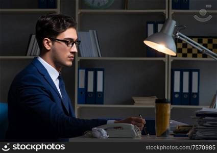 Employee working late to finish important deliverable task. The employee working late to finish important deliverable task