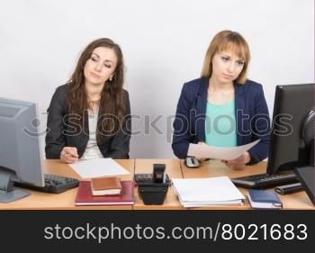 Employees of the office sitting at a desk with a view of the downtrodden