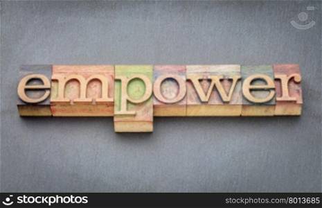 empower word banner in letterpress wood type printing blocks stained by color inks